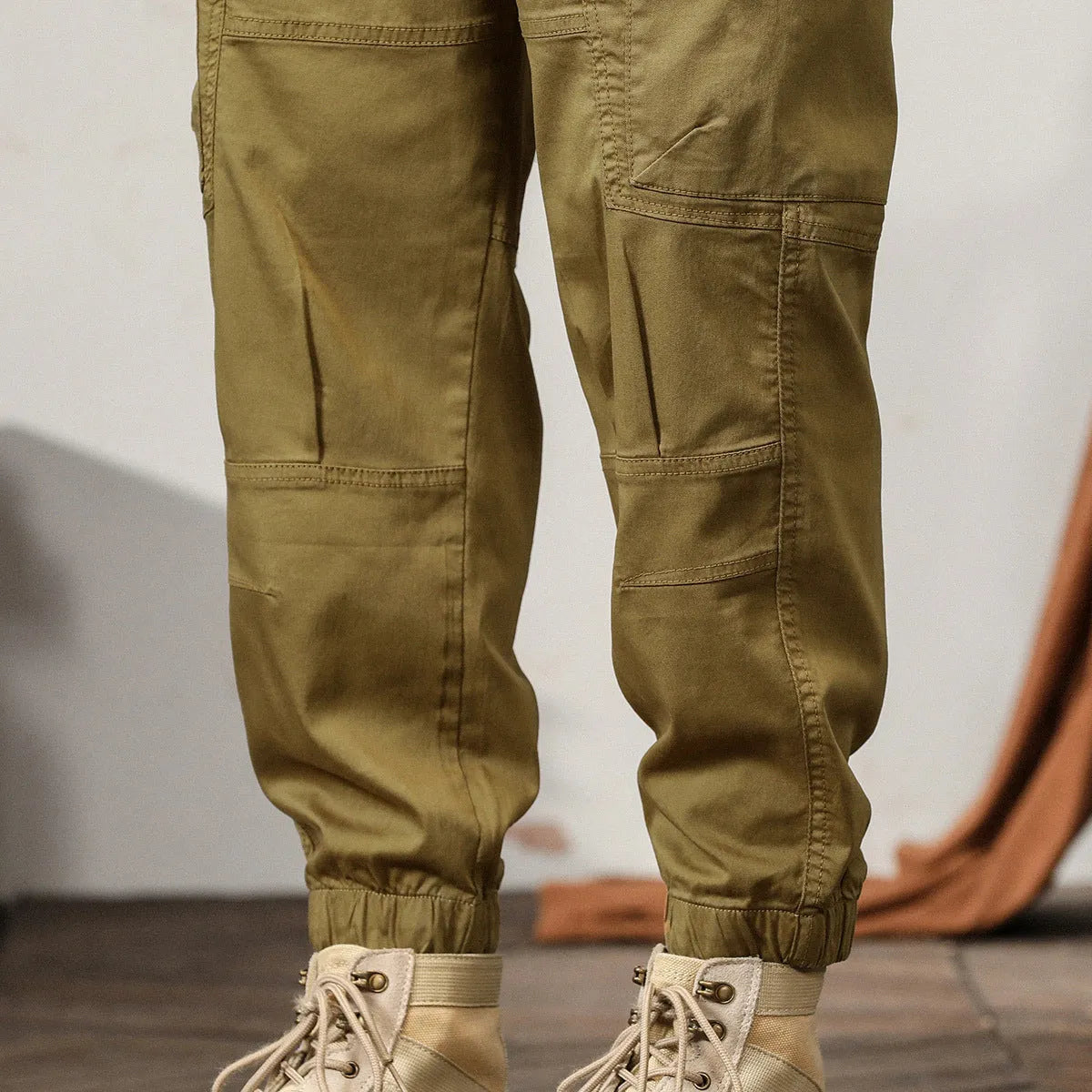 Men's loose khaki cotton harem trousers with tapered leg and ankle banding.