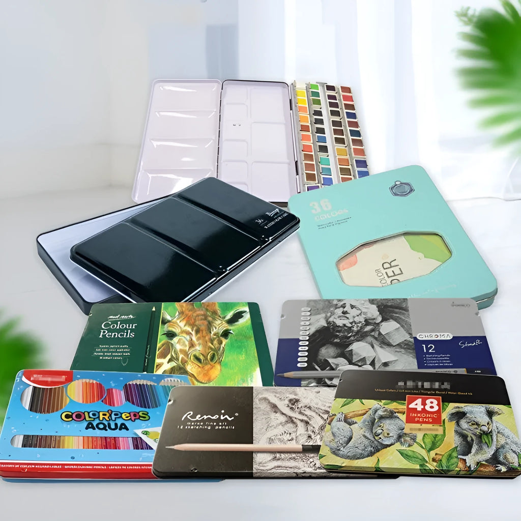 Square tinplate three-fold paint box for solid watercolours, shown open with empty slots.