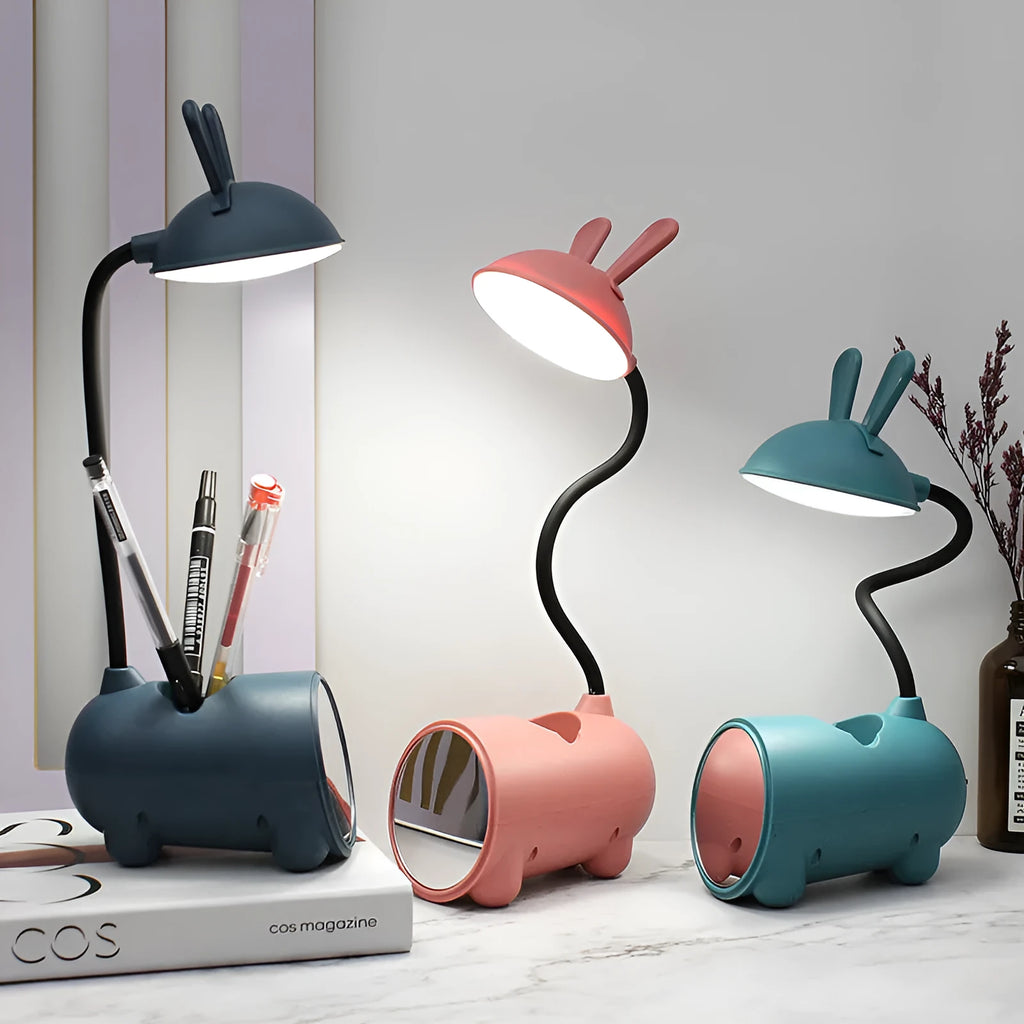 Green cartoon-themed USB table lamp with pen container base on desk