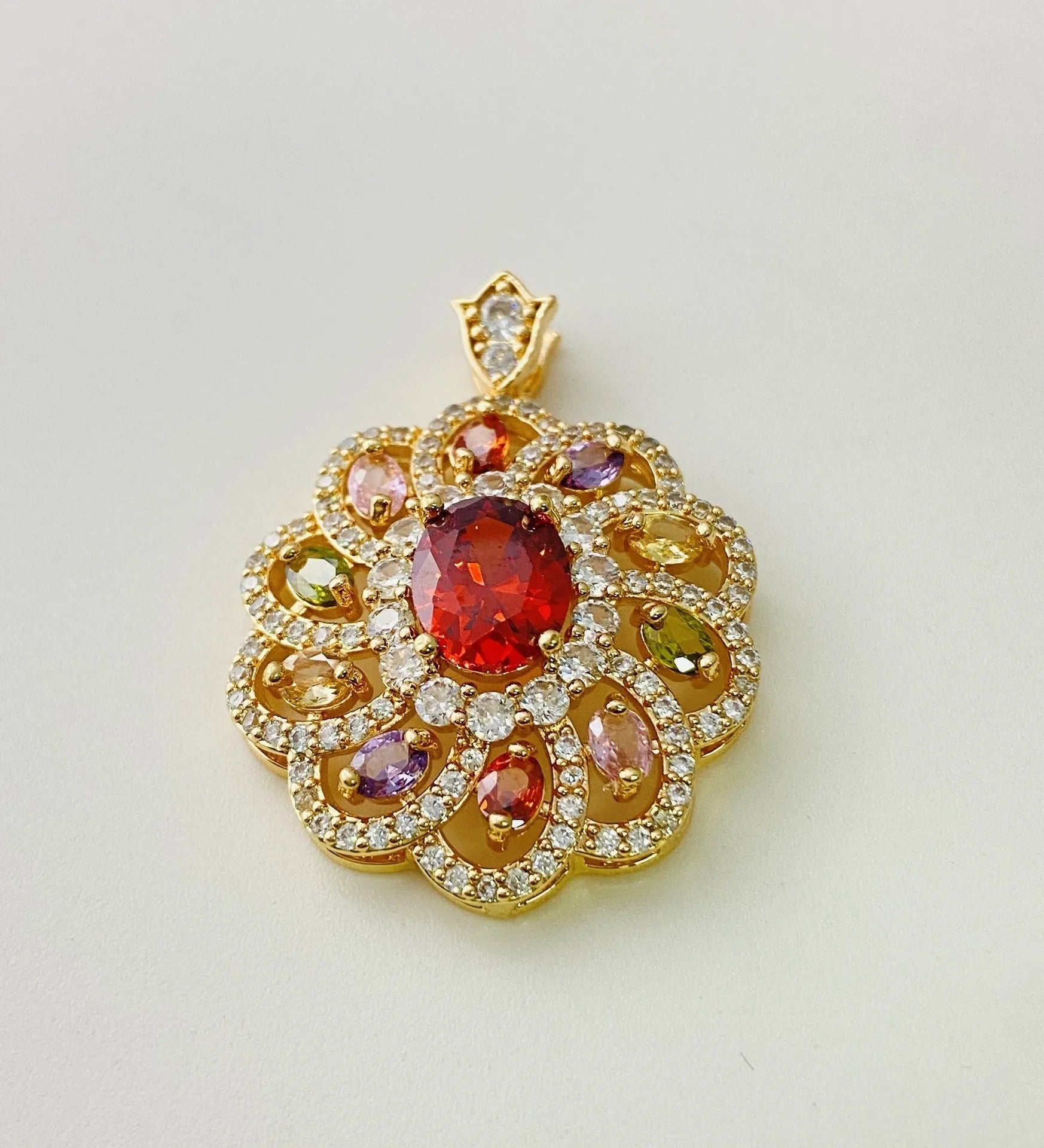 Close-up of a women's flower-shaped zircon pendant necklace in a gold electroplated finish on a model.