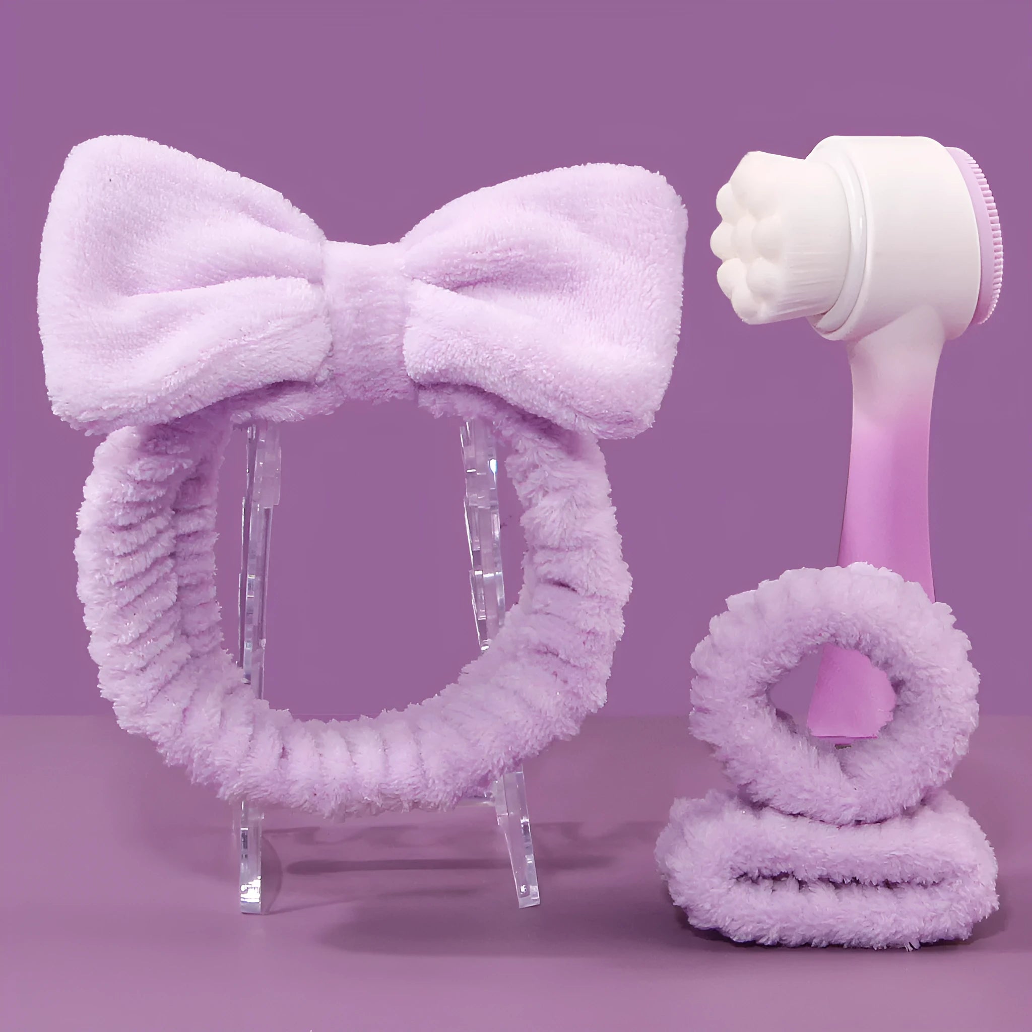 Facial brush set with coral fleece hair band, absorbent headband, and waterproof shower brush in purple colour