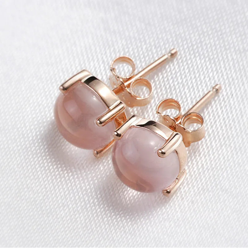 Rose gold drop shape stud earrings with synthetic ross quartz crystal inlay detail