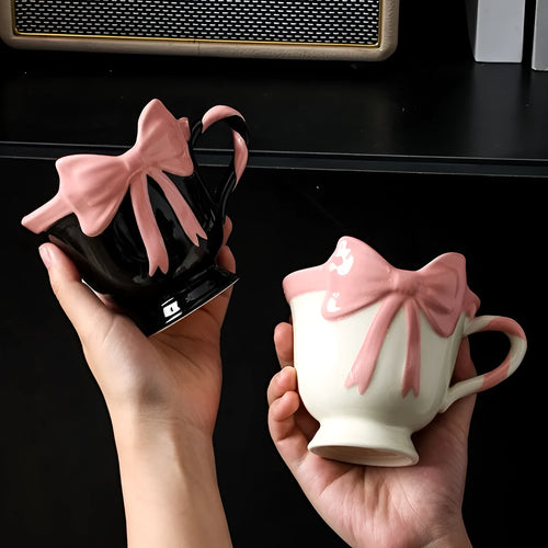 Ceramic mug with bow and heart design in white powder or black pink colours