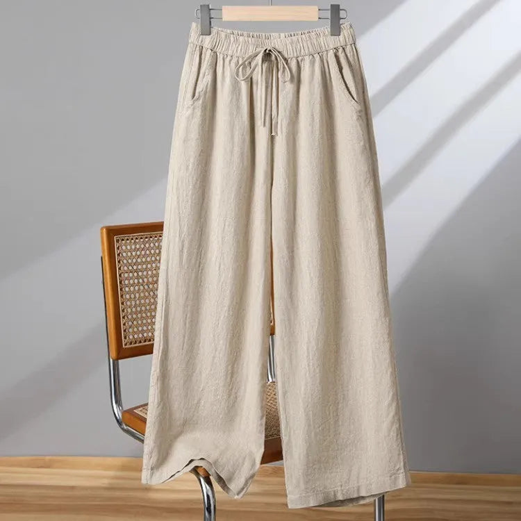 Women's apricot straight-leg casual trousers with elastic drawstring waist laid flat.