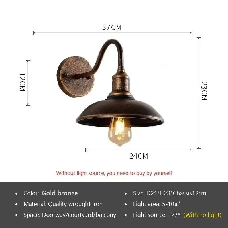 Retro style metal wall lamp in copper finish mounted on a stone wall.
