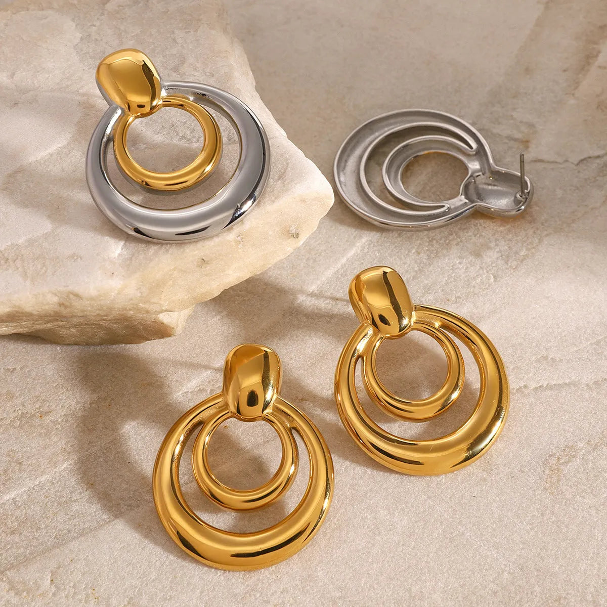 Gold geometric hollow stud earrings showing double layer round design with butterfly clutch backs