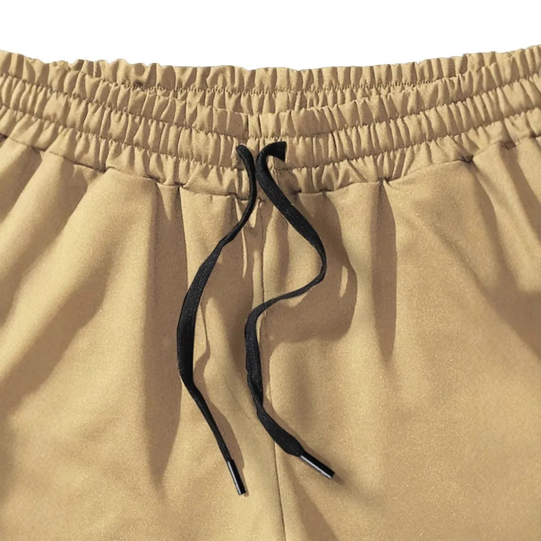 Men's khaki coconut print sports shorts with straight leg cut and elastic waistband