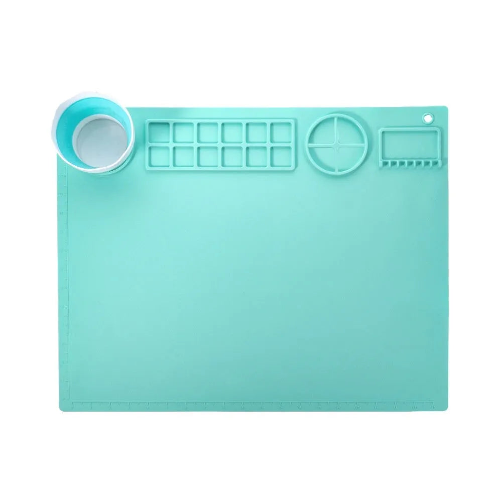 Light blue silicone painting mat with two round bowl compartments, measuring 50 by 40 cm.