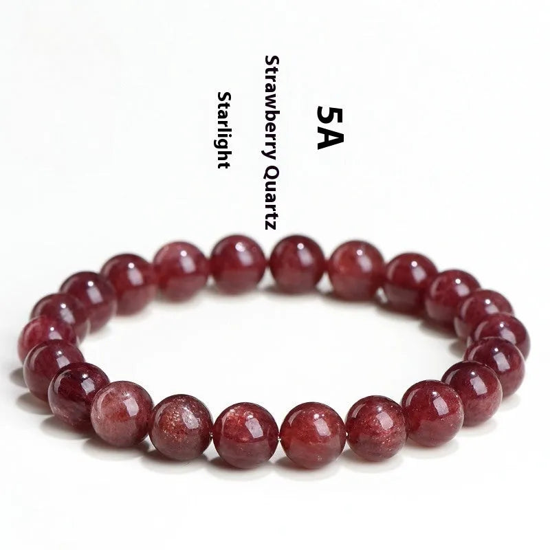 Natural strawberry quartz bracelet with geometric red crystal beads on a white background