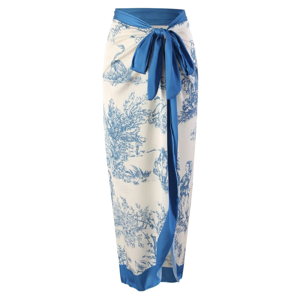 Blue patterned one-piece swimsuit for women shown with an optional matching gauze skirt.