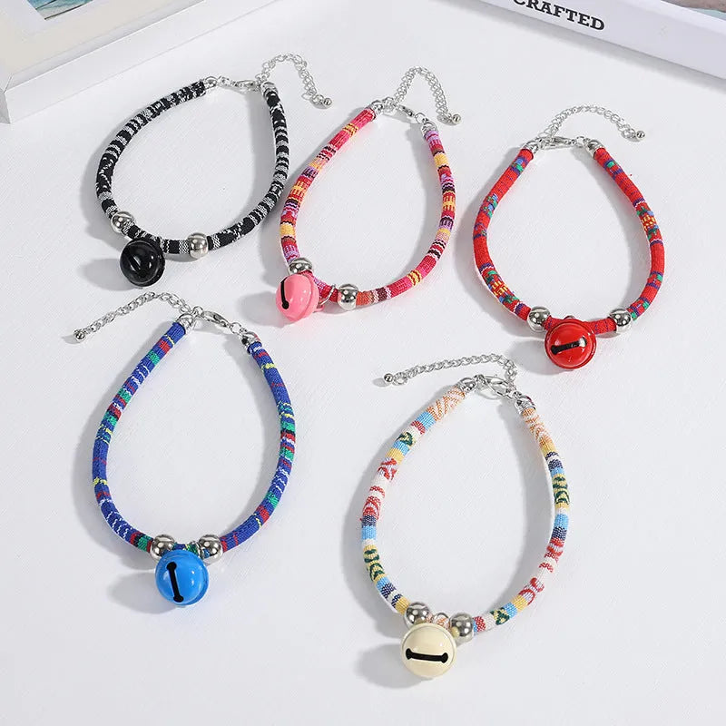 Ethnic patterned adjustable nylon pet collar with a metal buckle and bell in multiple colour options.
