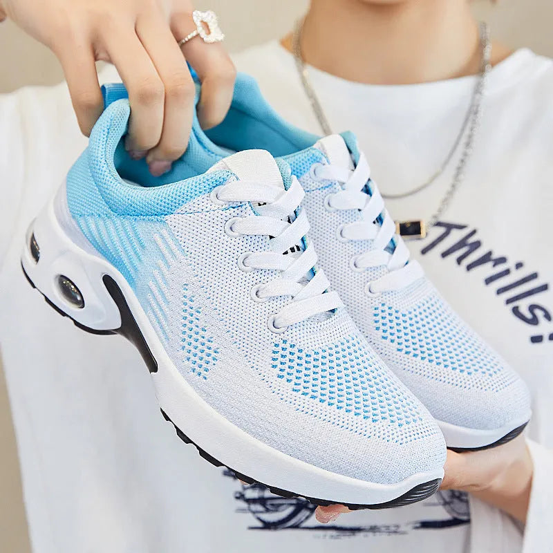 Women's Flyknit casual running shoes in striped pattern with lace-up front, shown in pink colour.