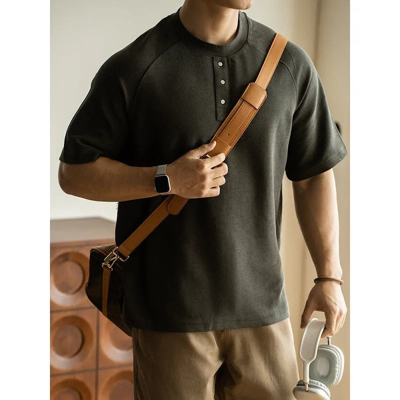 Women's loose grey casual pullover top with raglan sleeves on a hanger.