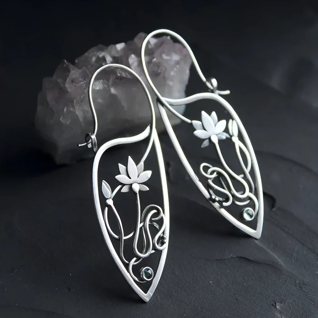 Silver lotus flower earrings with geometric shapes and rhinestone details