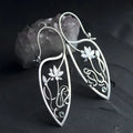 Silver lotus flower earrings with geometric shapes and rhinestone details