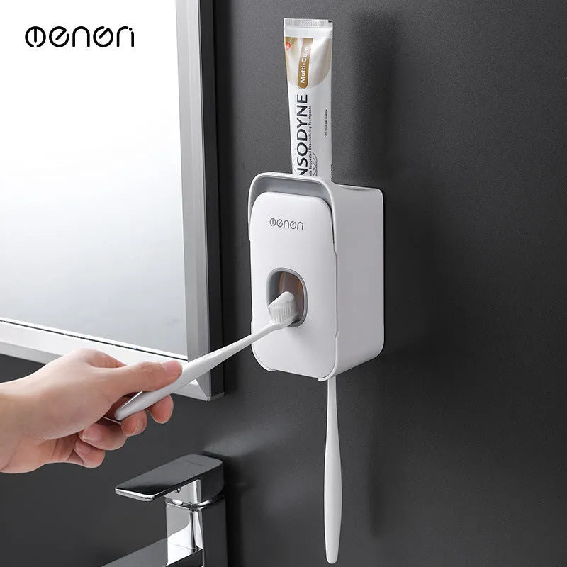 Blue automatic toothpaste dispenser with infrared sensor mounted on a bathroom wall.