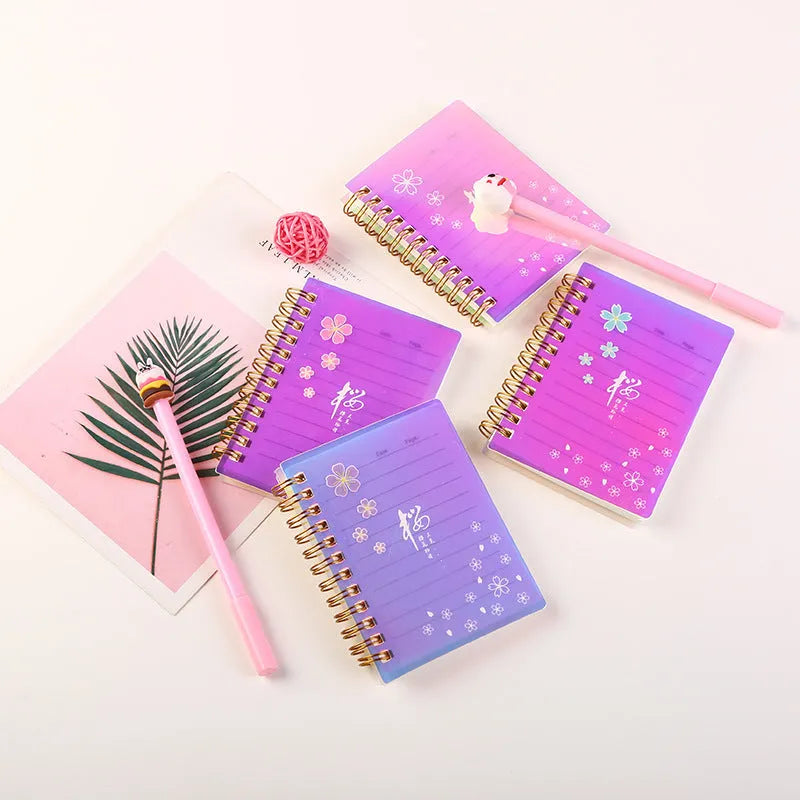 Pack of four rollover coil A7 pocket notebooks showing constellation, sakura, ocean, and universe cover designs