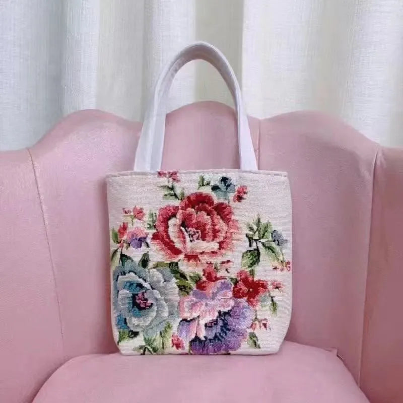 Handheld canvas bag with gold wire embroidery, shown in one of seven colour designs.
