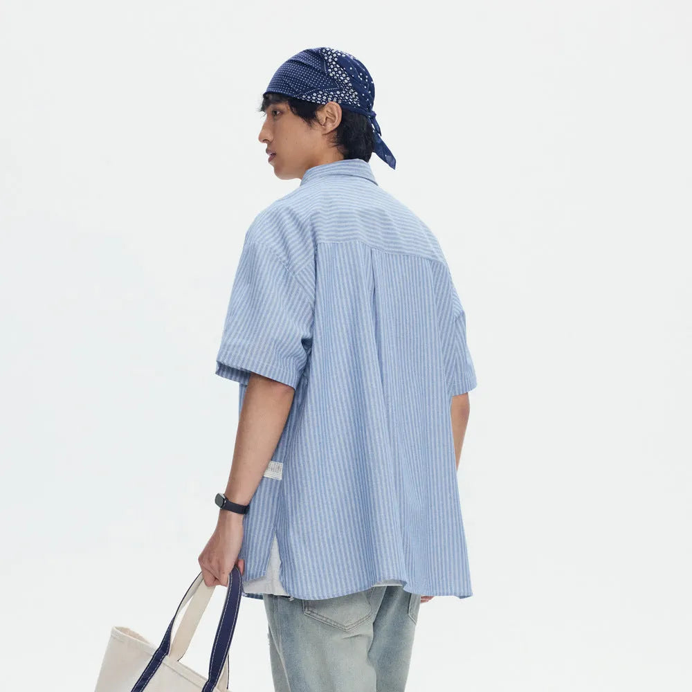 Blue and white striped loose-fitting short-sleeve cardigan shirt on a hanger