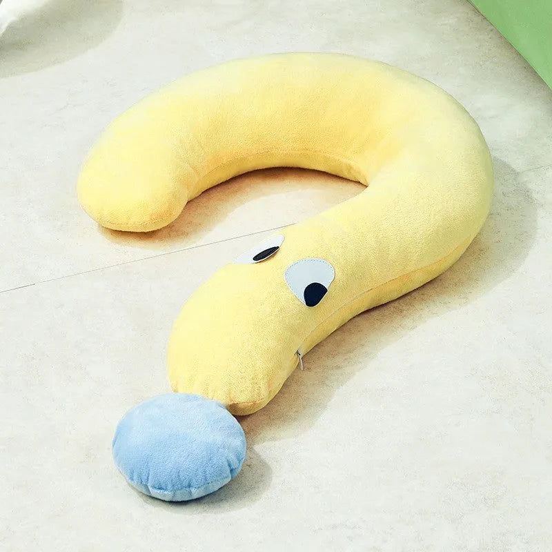 A rectangular blue pet sleeping pillow on a floor, shown next to a small dog for scale.
