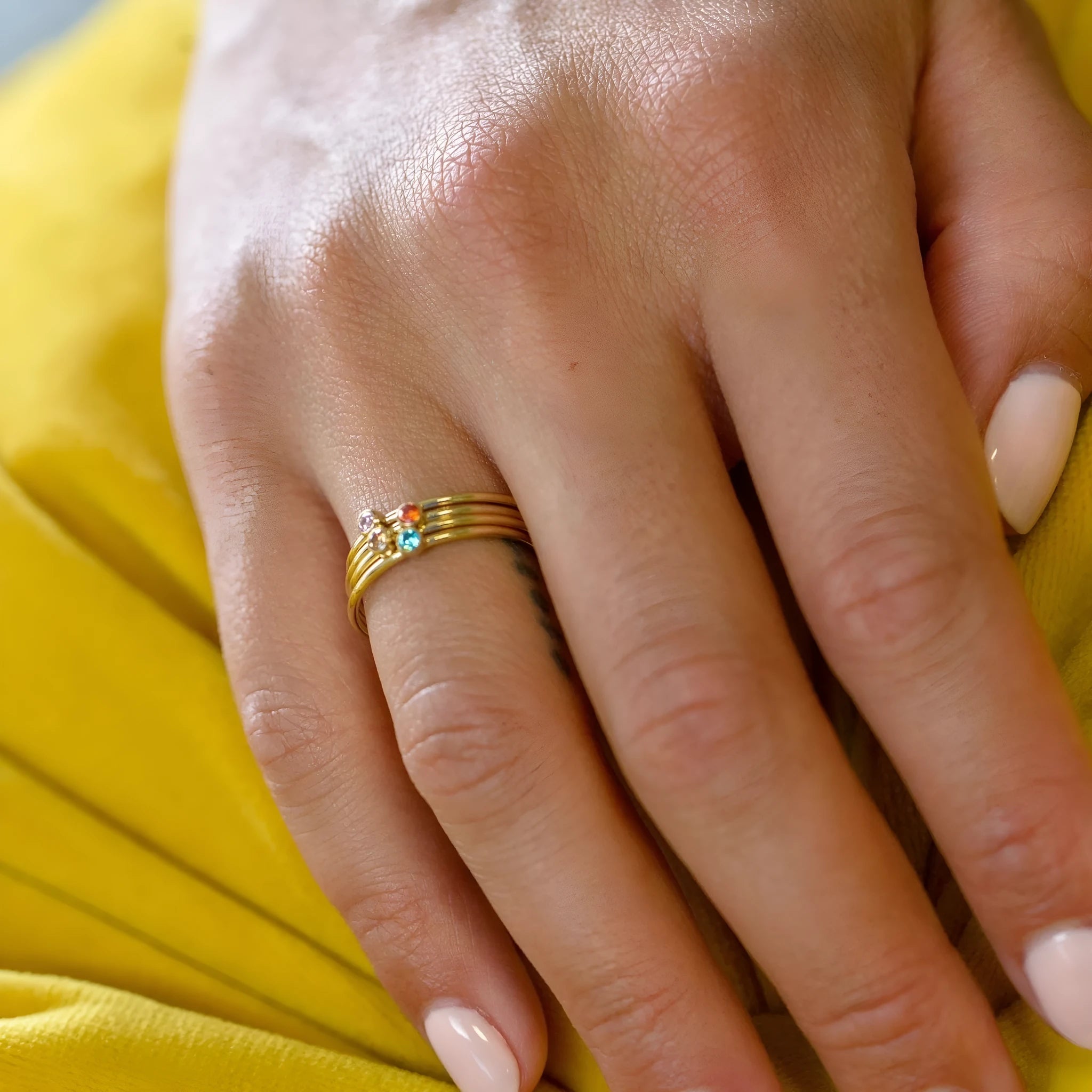 Geometric titanium steel ring featuring an engraved December birthstone design on a finger.