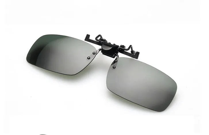 A pair of polycarbonate clip-on sunglasses for prescription glasses, shown in a dark green tint.