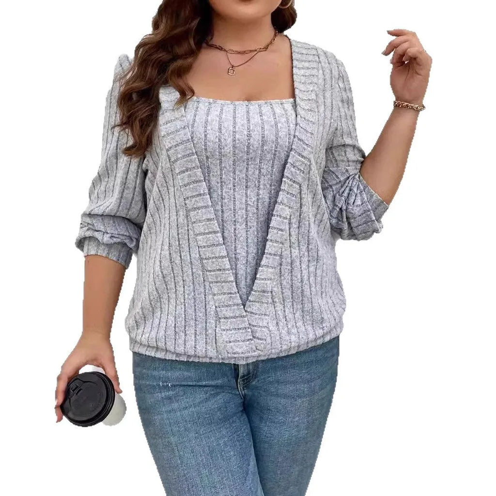 Women's solid colour ribbed V-neck false two-piece suit top with long sleeves on a hanger.