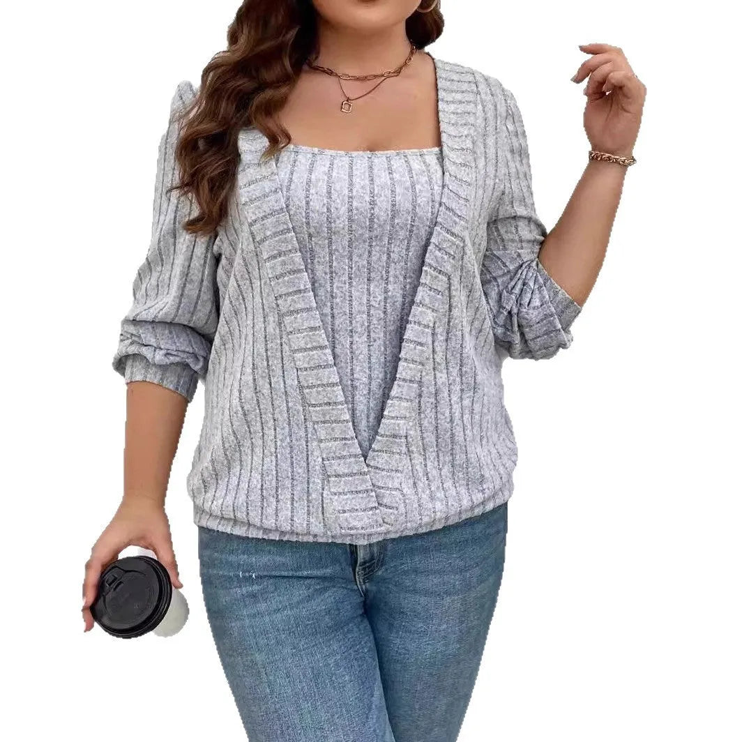 Women's solid colour ribbed V-neck false two-piece suit top with long sleeves on a hanger.