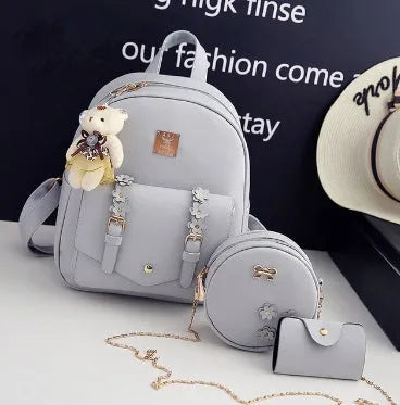 Women's three-piece backpack set with floral design including backpack, shoulder bag, and card holder