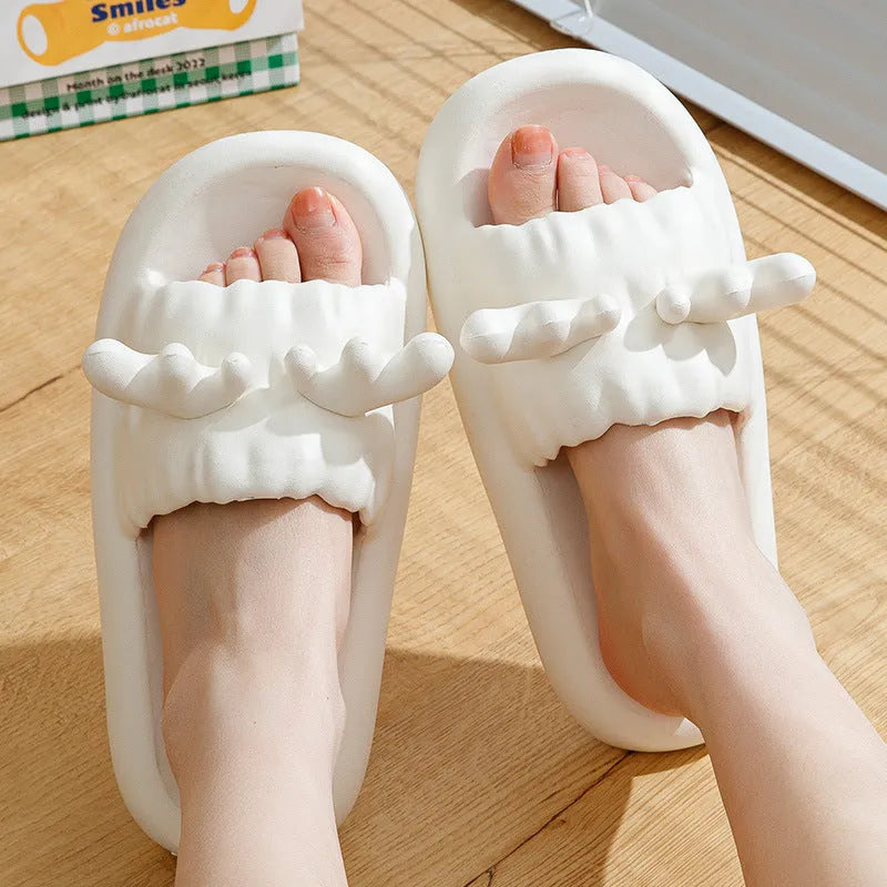 Light grey EVA flip flop slippers with a deer horn design and hollow out pattern on the upper.