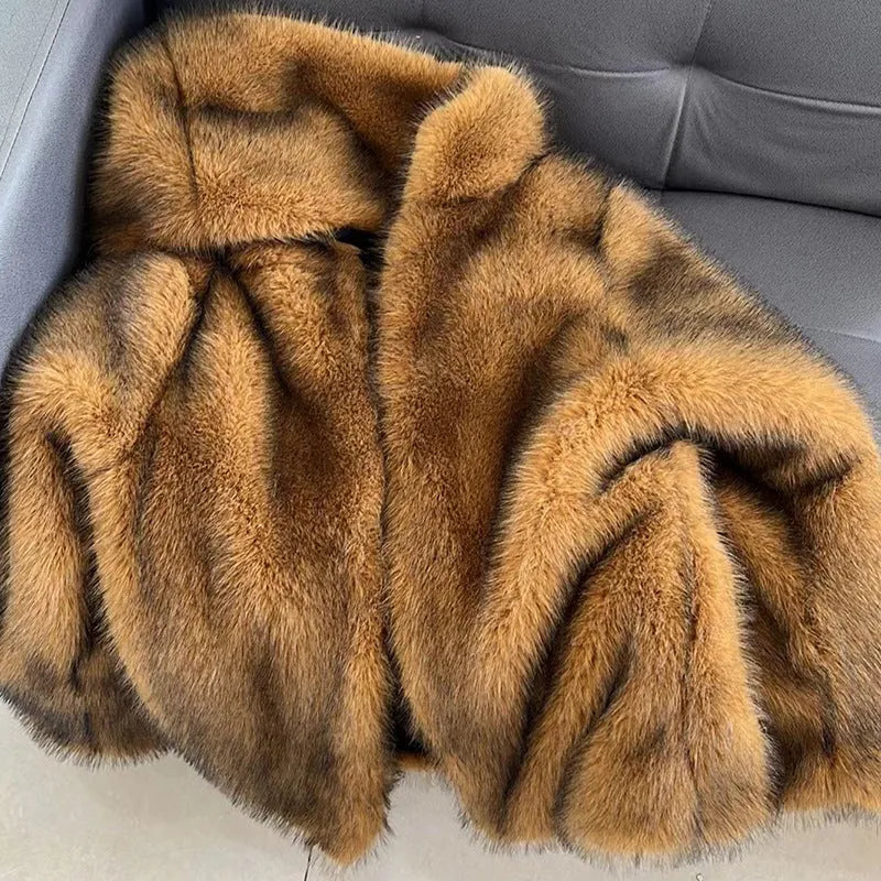 Silver grey loose mid-length artificial fur coat for women on a hanger.