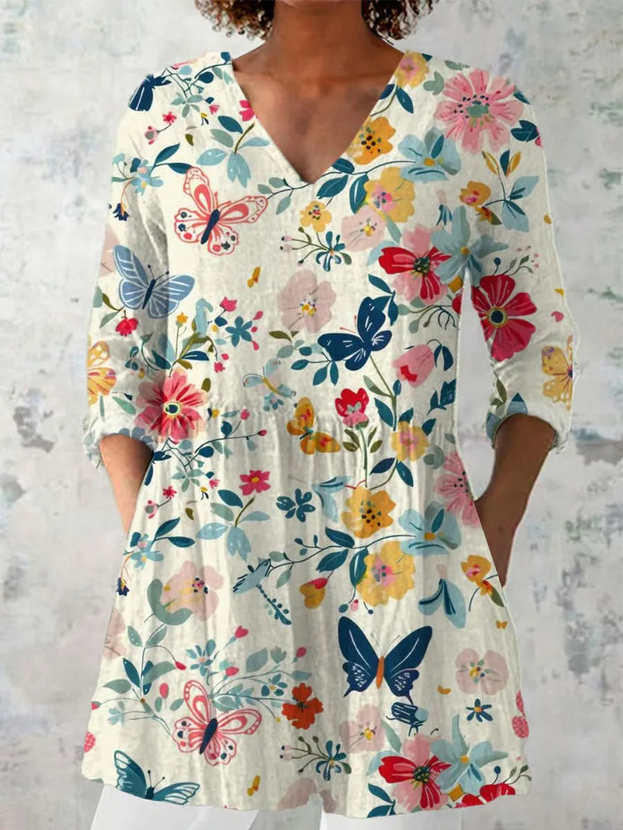 Women's slim-fit retro printed long-sleeved polyester top on a hanger, showing detail of digital print.