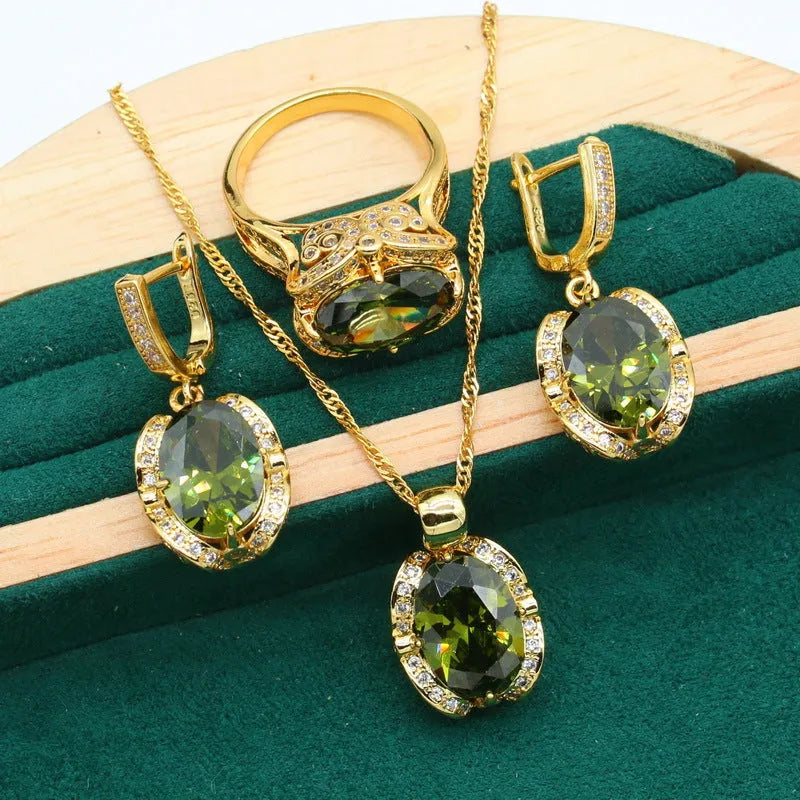 Olive green and red women's jewellery set with zircon stones, snake bone chain necklace, earrings, and ring.