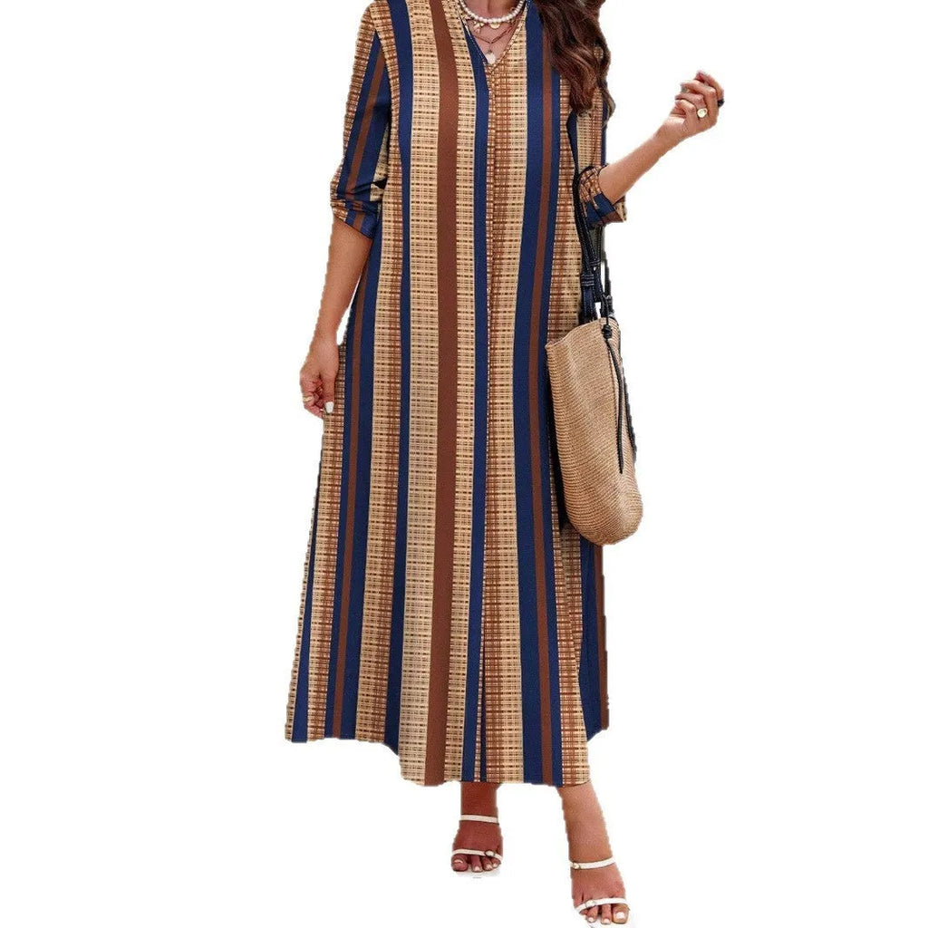 Camel-coloured women's long dress with vertical stripes, V-neck collar, and long sleeves on a mannequin.