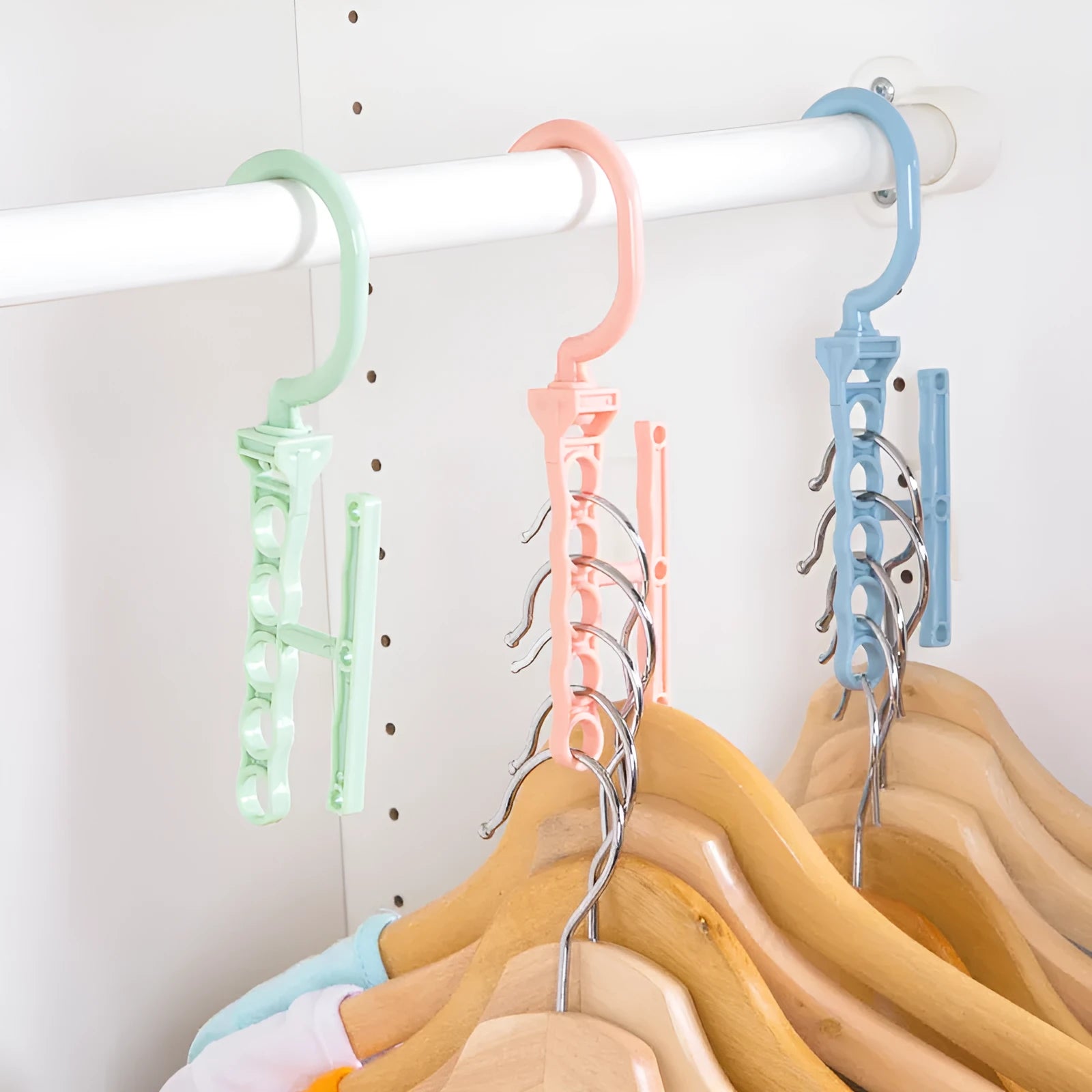 Blue revolving wardrobe hanger with five branches and handle for clothes organisation