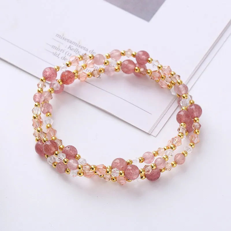 Women's handcrafted three-ring crystal bracelet with tourmaline, strawberry quartz, and amethyst beads on adjustable cord