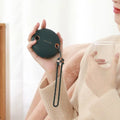 Green hand warmer power bank with digital display showing battery percentage and temperature settings