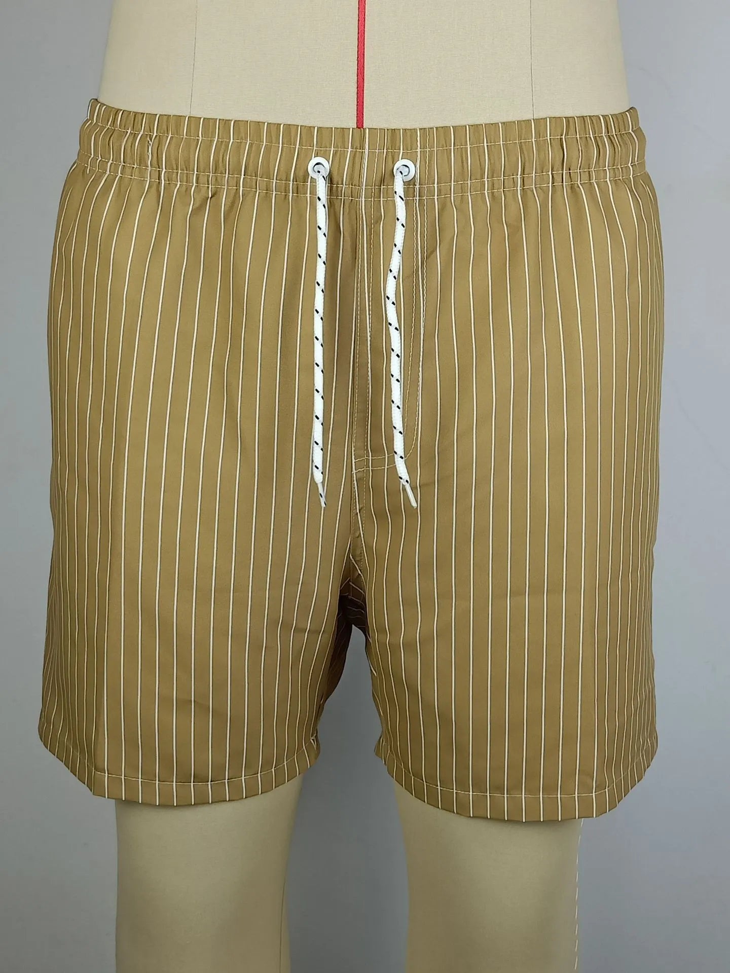 Men's striped beach shorts in polyester blend fabric, showing straight leg opening and available colour options.