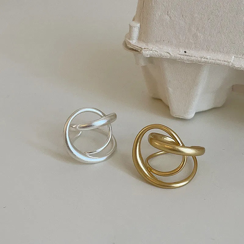 Geometric open ring with three-dimensional interlaced matte metal design in gold or silver electroplated finish