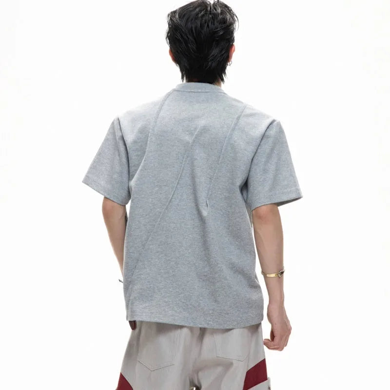 Men's loose fit cotton T-shirt with pleated detail and asymmetric stitching on a round neck, in solid black colour.