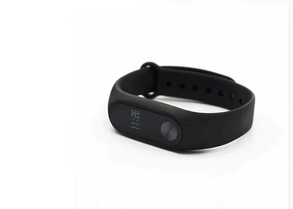 Black Xiaomi Mi Band 2 fitness tracker on wrist showing OLED display with heart rate data.