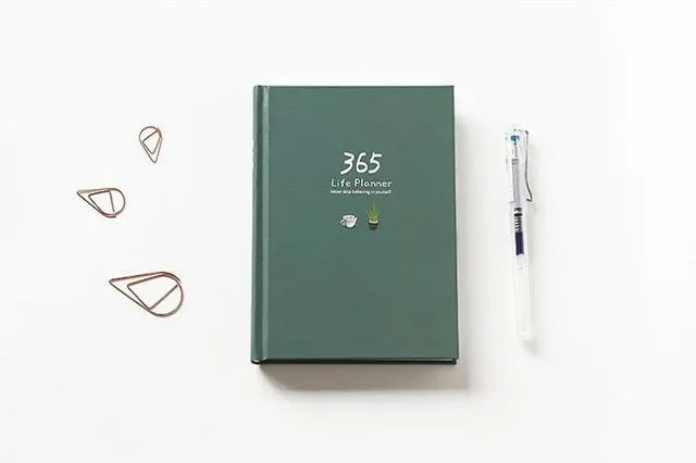 Hardback colour inside notebook planner with 228 pages, open to daily schedule, shown in Dark Green