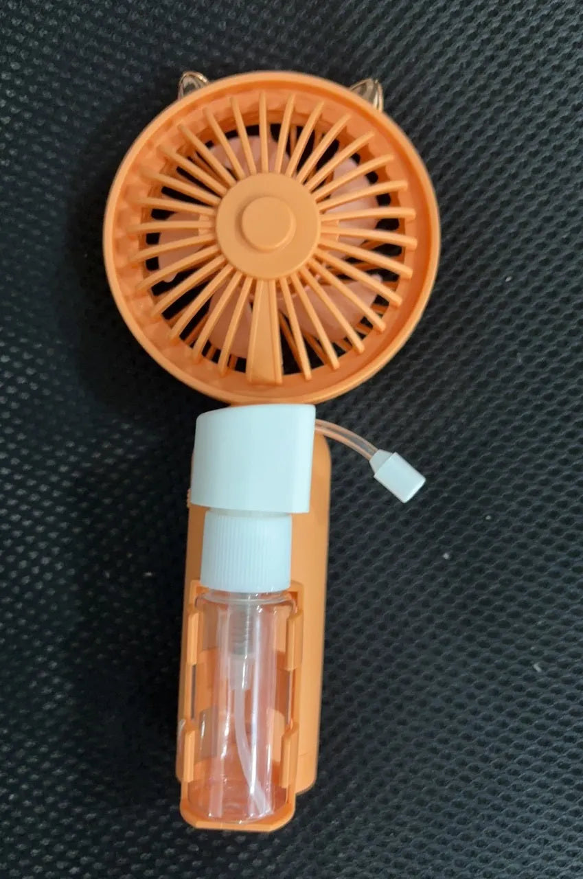Personalised plastic handheld desk fan with USB port in apricot colour, showing scale.
