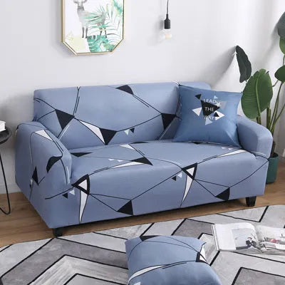 Geometric abstract printed stretch sofa slipcover covering a three-seater sofa with matching cushion covers.