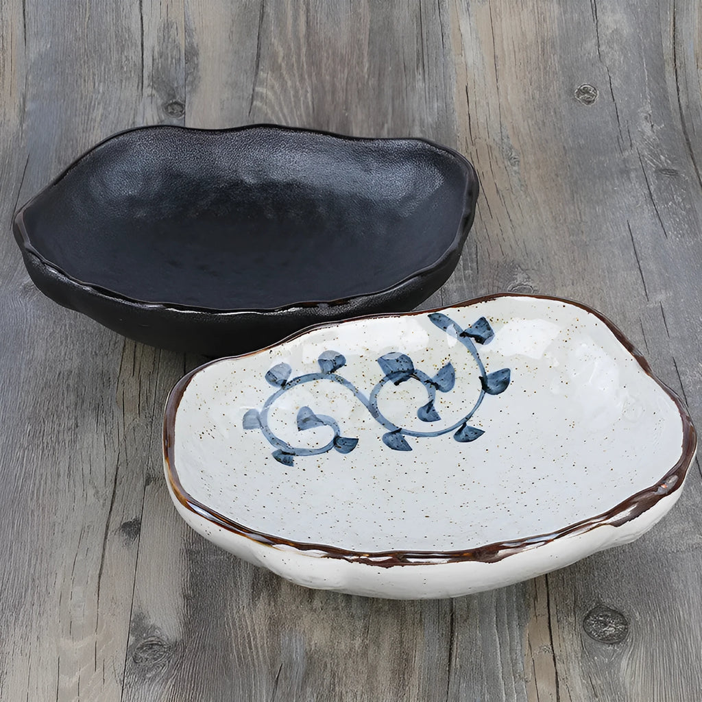 Creative Japanese style irregular shaped porcelain sashimi bowl with floral decoration and a small sauce dish