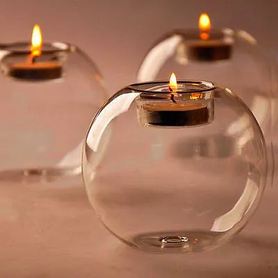 Handmade round hollow clear glass candle holder with a tea light inside, showing European style design.