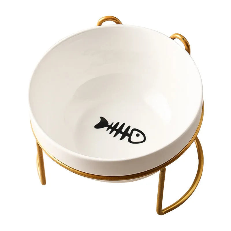 White ceramic cat bowl with decorative pattern sitting in a black iron frame stand.