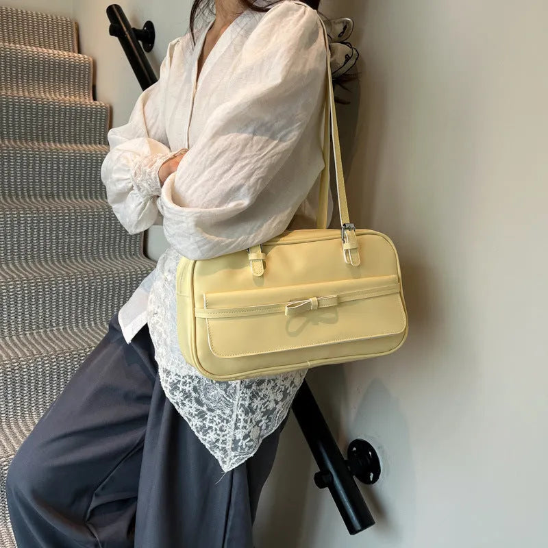 Women's black PU leather single shoulder flap bag with horizontal square shape and bow detail