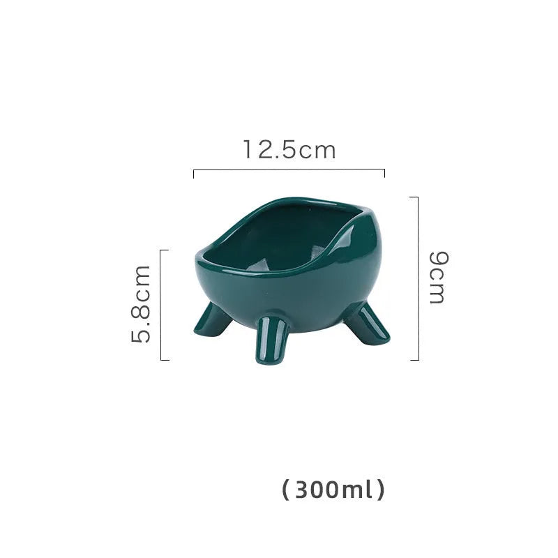 Green ceramic pet food bowl with four-legged base and rounded arc design