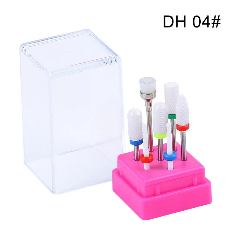 Set of seven tungsten steel nail drill bits and a brush in a clear plastic case.